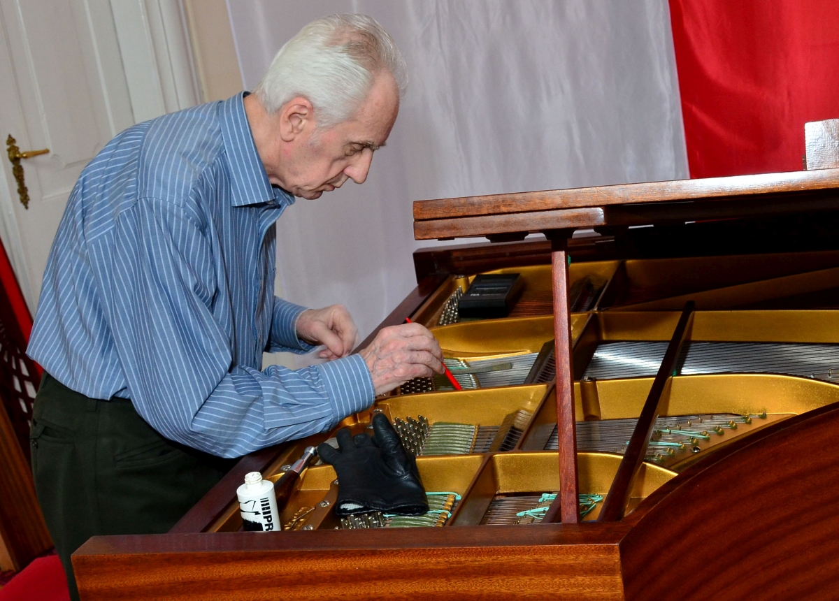 Juliusz Adamowski przy pracy jako stroiciel i korektor dźwięku konkursowych fortepianów